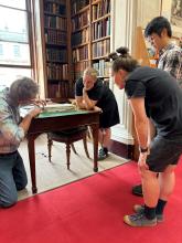 Conservator demonstrating disbinding to the students.