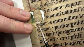 Applying a Japanese paper disc as a repair using wheat starch paste